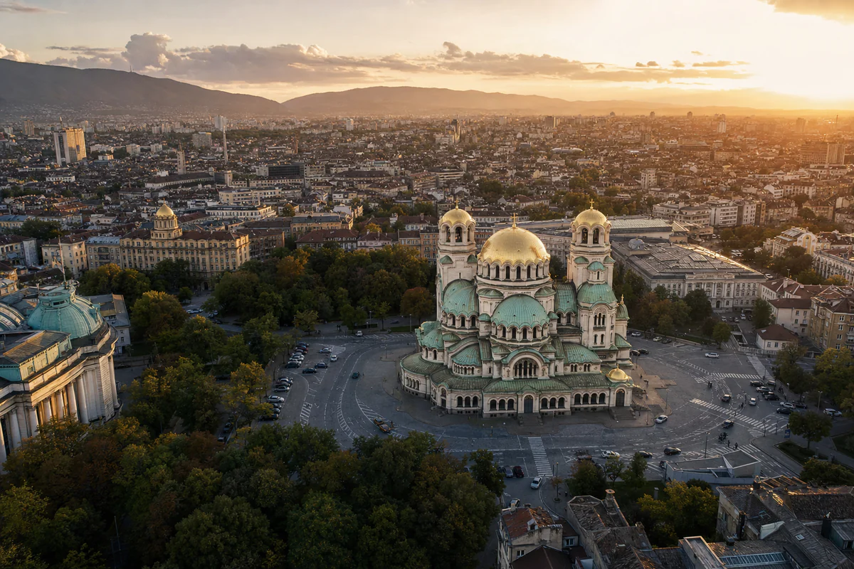 Golden-hour aerial view of Sofia with Alexander Nevsky Cathedral and the surrounding Bulgarian cityscape.