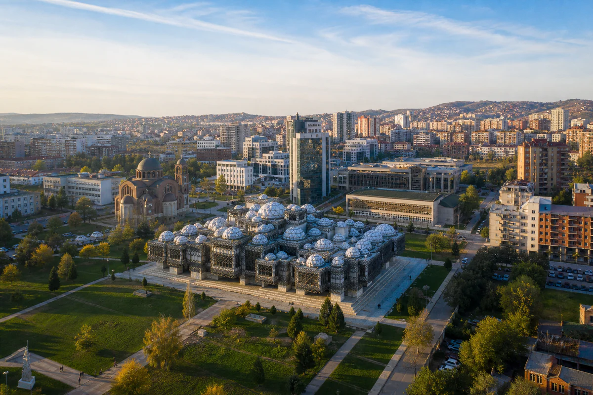 Early-morning aerial view of Pristina with Kosovo's distinctive National Library and city skyline.