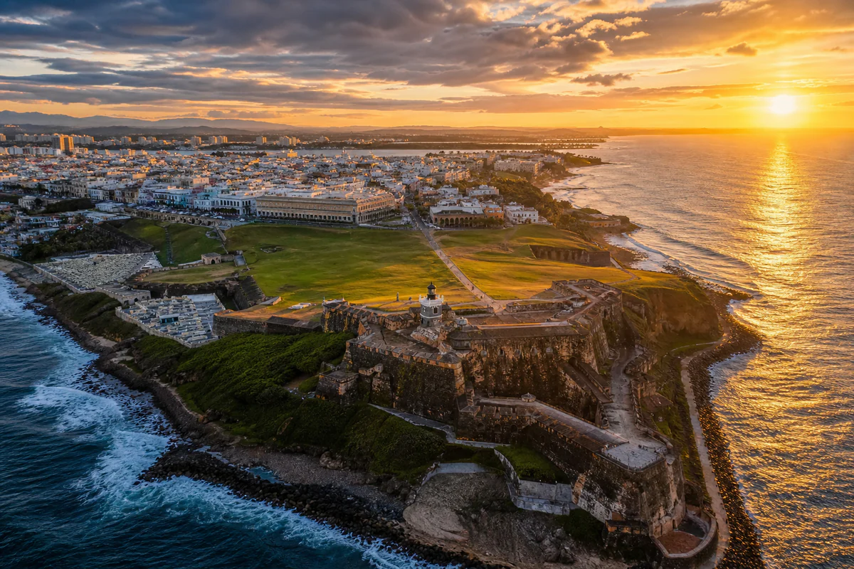 Sunrise aerial over Old San Juan and Castillo San Felipe del Morro beside Puerto Rico's Atlantic coast.
